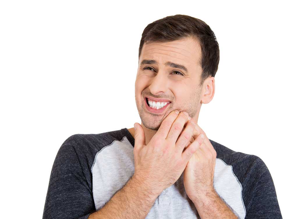 Close up image of a guy having very bad toothache